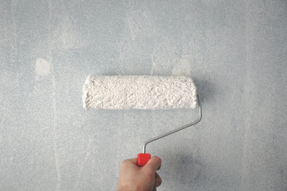 Painter applying paint with a roller
